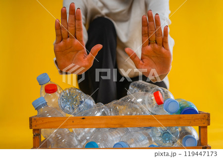 cropped view prohibit hand gesture and plastic bottle in wooden box storage cropped view prohibit hand gesture and plastic bottle in wooden box storage 119447173