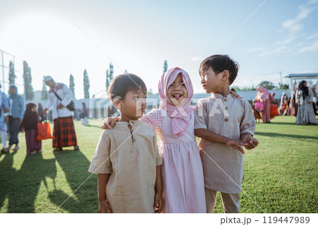 Children in Traditional Attire Joyfully Celebrating at an Outdoor Event Children in Traditional Attire Joyfully Celebrating at an Outdoor Event 119447989