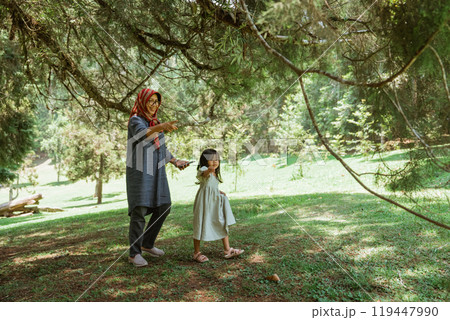 A Mother and Daughter are Enjoying the Beauty of Nature Together in a Serene Setting A Mother and Daughter are Enjoying the Beauty of Nature Together in a Serene Setting 119447990