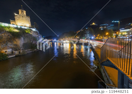 Night view over the Kura River in Tbilisi, Georgia, with city lights reflecting on the water Night view over the Kura River in Tbilisi, Georgia, with city lights reflecting on the water 119448251