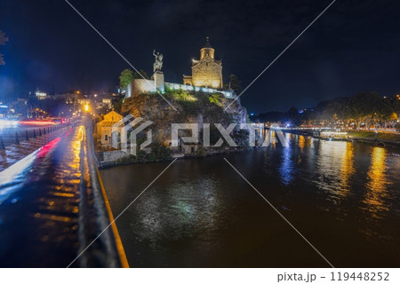 Night view over the Kura River in Tbilisi, Georgia, with city lights reflecting on the water Night view over the Kura River in Tbilisi, Georgia, with city lights reflecting on the water 119448252
