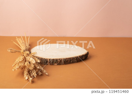 The podium is made of natural wood and decorated with spikelets. Showcase, product presentation. 119451460