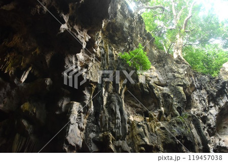 stalagmites and stalactites with sunlight through cave hole in Khao Luang cave travel location on Thailand 119457038