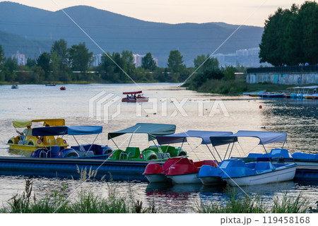 Pier with pleasure catamarans on the river. 119458168