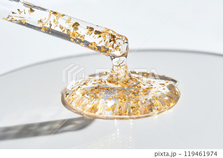 Luxurious translucent serum with gold flakes in dropper for premium skincare Luxurious translucent serum with gold flakes in dropper for premium skincare 119461974