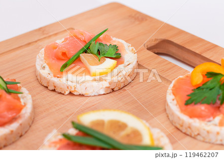 Rice Cake Sandwiches with Fresh Salmon, Cucumber, Lemon and Greens 119462207
