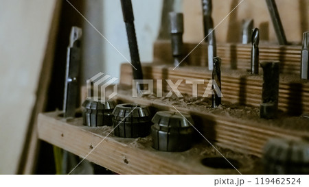 Various tools: file, screwdriver, hammer, pliers, garden tools are displayed on wooden shelf inside rustic garage or manufactory, workshop studio in a rustic garden house. Hobby, leasure activity Various tools: file, screwdriver, hammer, pliers, garden tools are displayed on wooden shelf inside rustic garage or manufactory, workshop studio in a rustic garden house. Hobby, leasure activity 119462524