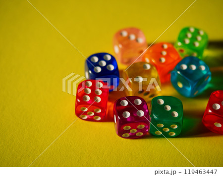 Color dices on yellow paper background. Cardboard bright background with texture. Concept of luck, testing fate, lottery, decision making. Place for text. Copy space. Rovinj, Croatia - October 4, 2024 Color dices on yellow paper background. Cardboard bright background with texture. Concept of luck, testing fate, lottery, decision making. Place for text. Copy space. Rovinj, Croatia - October 4, 2024 119463447