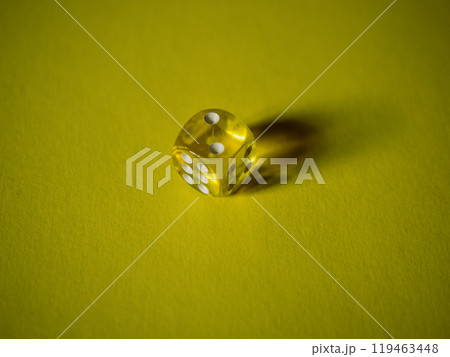 Slick dice on yellow paper background. Cardboard bright background with texture. Concept of luck, testing fate, lottery, decision making. Place for text. Copy space. Rovinj, Croatia - October 4, 2024 Slick dice on yellow paper background. Cardboard bright background with texture. Concept of luck, testing fate, lottery, decision making. Place for text. Copy space. Rovinj, Croatia - October 4, 2024 119463448