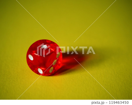 Red dice on yellow paper background. Cardboard bright background with texture. Concept of luck, testing fate, lottery, decision making. Place for text. Copy space. Rovinj, Croatia - October 4, 2024 Red dice on yellow paper background. Cardboard bright background with texture. Concept of luck, testing fate, lottery, decision making. Place for text. Copy space. Rovinj, Croatia - October 4, 2024 119463450