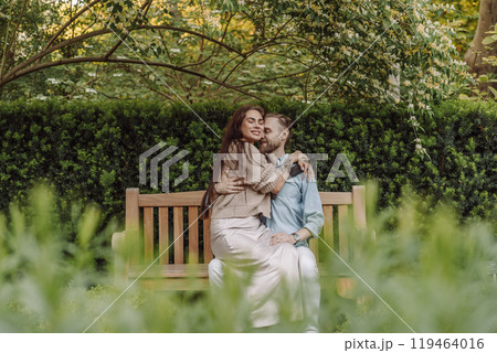 Happy loving couple enjoying their time together in park. Loving couple spending time together. Girl with tattoos. Tattooed woman. Beautiful fashionable couple of lovers on the street. Happy loving couple enjoying their time together in park. Loving couple spending time together. Girl with tattoos. Tattooed woman. Beautiful fashionable couple of lovers on the street. 119464016