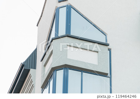 Modern architectural design showcasing a sleek glass corner of a contemporary building Modern architectural design showcasing a sleek glass corner of a contemporary building 119464246