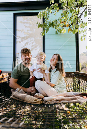 Smiling family enjoying warm embrace together outdoors, capturing essence of love and togetherness Smiling family enjoying warm embrace together outdoors, capturing essence of love and togetherness 119464542