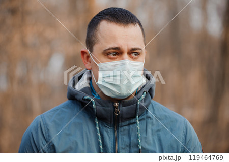 Young Man Wearing a Face Mask in a Forest during Daylight 119464769