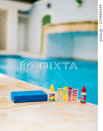 Chlorine and ph tester for swimming pools. Water test kit on the edge of the swimming pool. Chlorine test kit for swimming pools 119466444