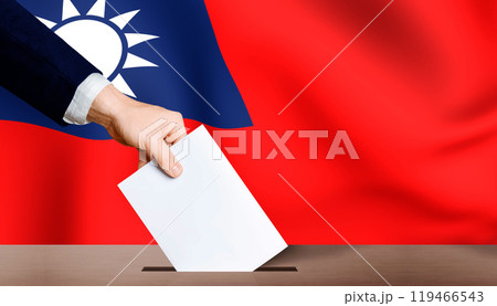 Hand holding ballot in ballot box with Taiwan flag in background. Taiwan presidential election 119466543