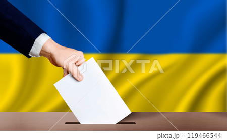 Hand holding ballot in voting ballot box with ukraine flag in background. People puts ballot paper in voting box on Ukraine flag background. Ukraine electoral elections, concept 119466544