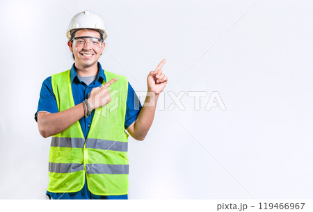Happy male engineer pointing to side isolated. Smiling male engineer pointing blank space isolated Happy male engineer pointing to side isolated. Smiling male engineer pointing blank space isolated 119466967