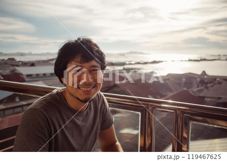 Smile man enjoy the happy moment with sunset and sea view. Smile man enjoy the happy moment with sunset and sea view. 119467625