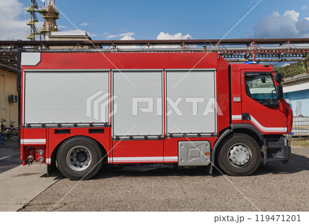 A state-of-the-art firetruck, equipped with advanced rescue technology, stands ready with its skilled firefighting team, prepared to intervene and respond rapidly to emergencies, ensuring the safety A state-of-the-art firetruck, equipped with advanced rescue technology, stands ready with its skilled firefighting team, prepared to intervene and respond rapidly to emergencies, ensuring the safety 119471201