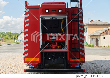 A state-of-the-art firetruck, equipped with advanced rescue technology, stands ready with its skilled firefighting team, prepared to intervene and respond rapidly to emergencies, ensuring the safety A state-of-the-art firetruck, equipped with advanced rescue technology, stands ready with its skilled firefighting team, prepared to intervene and respond rapidly to emergencies, ensuring the safety 119471206