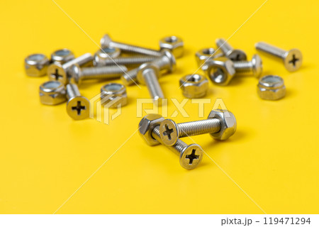 metal screw over yellow background. metal screw over yellow background. 119471294