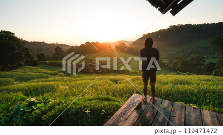 Rural rice field tour, man standing taking pictures on the rice field terrace and morning light 119471472