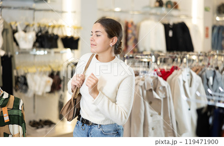 Young woman chooses clothes in store 119471900