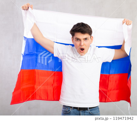 Portrait of positive young man with flag of Russia Portrait of positive young man with flag of Russia 119471942