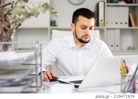 Man office worker using laptop during workday 119471974