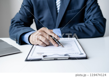 Business man employer holding resume hiring recruit looking cv resume to hire candidates, analyzing information before job interview. Recruitment concepts 119474124