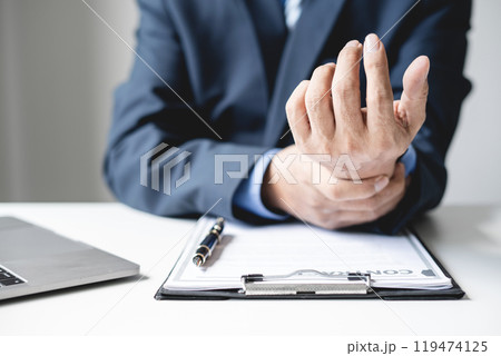 man hand with wrist pain numbness and pain in the palm of the hand has pain and tingling in the nerve endings This is a side effect of sitting and working for a long time on a laptop at the office 119474125