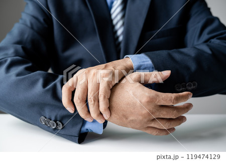 man hand with wrist pain numbness and pain in the palm of the hand has pain and tingling in the nerve endings This is a side effect of sitting and working for a long time on a laptop at the office 119474129