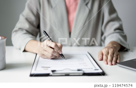 Business woman employer holding resume hiring recruit looking cv resume to hire candidates, analyzing information before job interview. Recruitment concepts Business woman employer holding resume hiring recruit looking cv resume to hire candidates, analyzing information before job interview. Recruitment concepts 119474574
