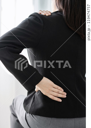 Woman having back and shoulder pain pain during work long time. stretching to relax and relax while working hard at the office Woman having back and shoulder pain pain during work long time. stretching to relax and relax while working hard at the office 119474757