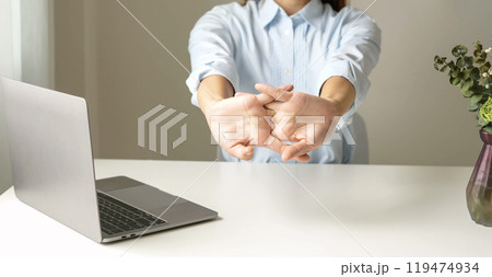 Woman hand with wrist pain numbness and pain in the palm of the hand has pain and tingling in the nerve endings This is a side effect of sitting and working for a long time on a laptop at the office Woman hand with wrist pain numbness and pain in the palm of the hand has pain and tingling in the nerve endings This is a side effect of sitting and working for a long time on a laptop at the office 119474934
