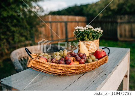 Wicker basket full of harvested fruits from the garden. Autumn harvest. Fall season. Wicker basket full of harvested fruits from the garden. Autumn harvest. Fall season. 119475788