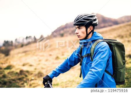 Active man on bike in the middle of beautiful nature, enjoying beautiful view. Concept of healthy lifestyle. 119475916