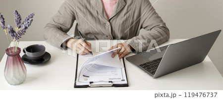 Business woman employer holding resume hiring recruit looking cv resume to hire candidates, analyzing information before job interview. Recruitment concepts Business woman employer holding resume hiring recruit looking cv resume to hire candidates, analyzing information before job interview. Recruitment concepts 119476737