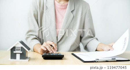 Agents working in real estate investment and home insurance signing contracts in accordance with the home buying insurance agreements approving purchases for clients.home insurance concept 119477045