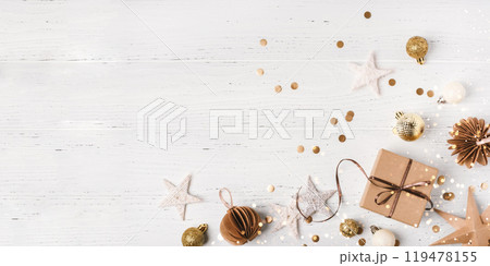 Festive Christmas background with gift box and Christmas decorations on white wooden table. Top view. Copy space for text. 119478155