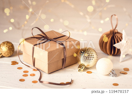 Christmas gift box and decorations on white wooden table. Front view. 119478157