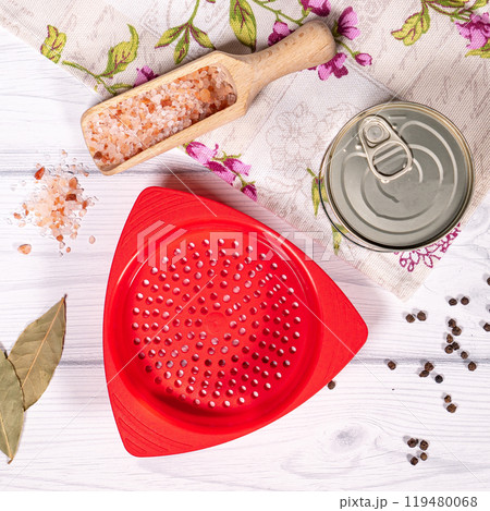 Small red plastic colander. Colander of modern plastic strainer in the kitchen table Small red plastic colander. Colander of modern plastic strainer in the kitchen table 119480068
