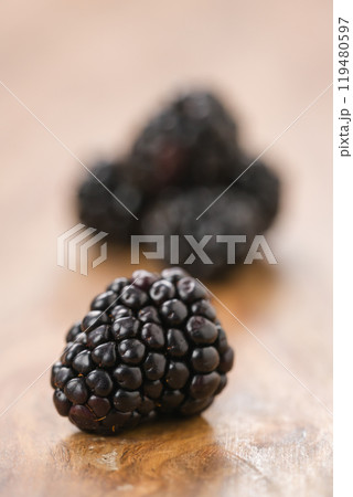 Closeup ripe blackberries on wood background Closeup ripe blackberries on wood background 119480597