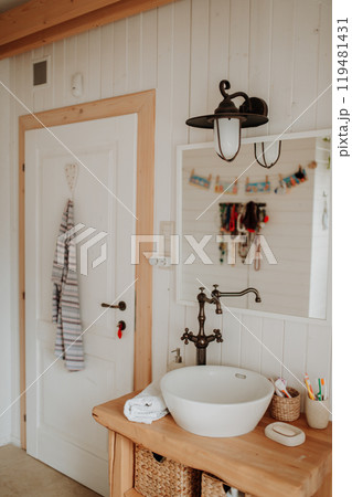 Modern attic bathroom with a wooden sink table. Modern attic bathroom with a wooden sink table. 119481431