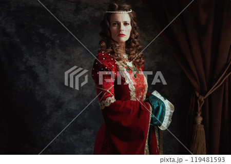 medieval queen in red dress on dark gray background medieval queen in red dress on dark gray background 119481593