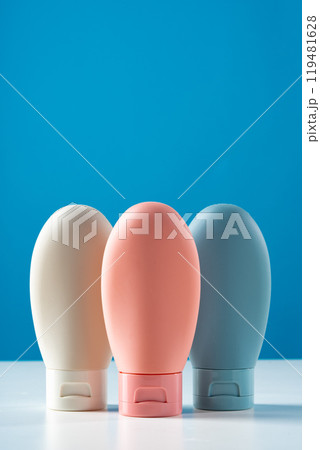 Variety of travel-sized containers displayed against a bright blue background Variety of travel-sized containers displayed against a bright blue background 119481628