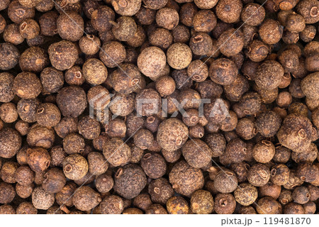 Black peppercorns as a background. Dry black pepper seeds. Top view 119481870