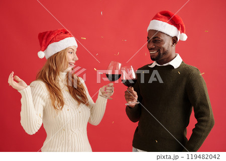 Smiling Couple Celebrating Christmas with Wine Glasses 119482042