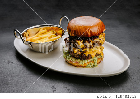 Delicious double cheeseburger with fries, perfect for fast food lovers and culinary enthusiasts Delicious double cheeseburger with fries, perfect for fast food lovers and culinary enthusiasts 119482315
